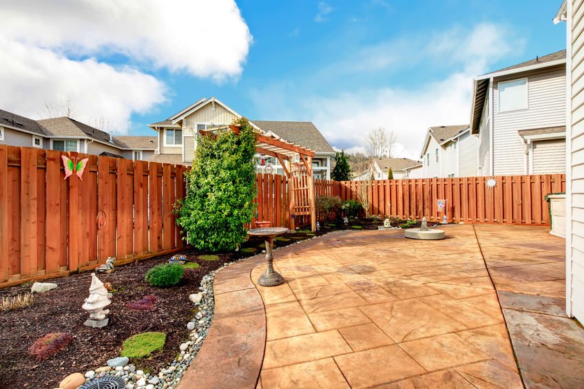 26094535 - fenced backyard with concrete tile floor deck and decorated flower bed